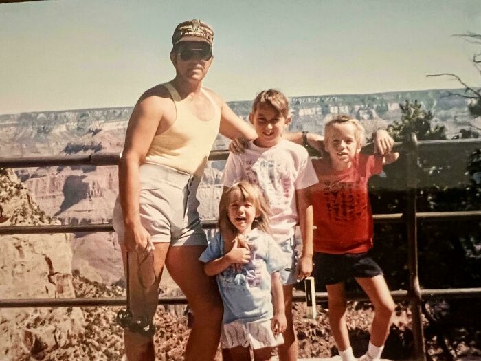 A family enjoying a sunny day at the Grand Canyon, capturing an old moment of past adventure and togetherness.