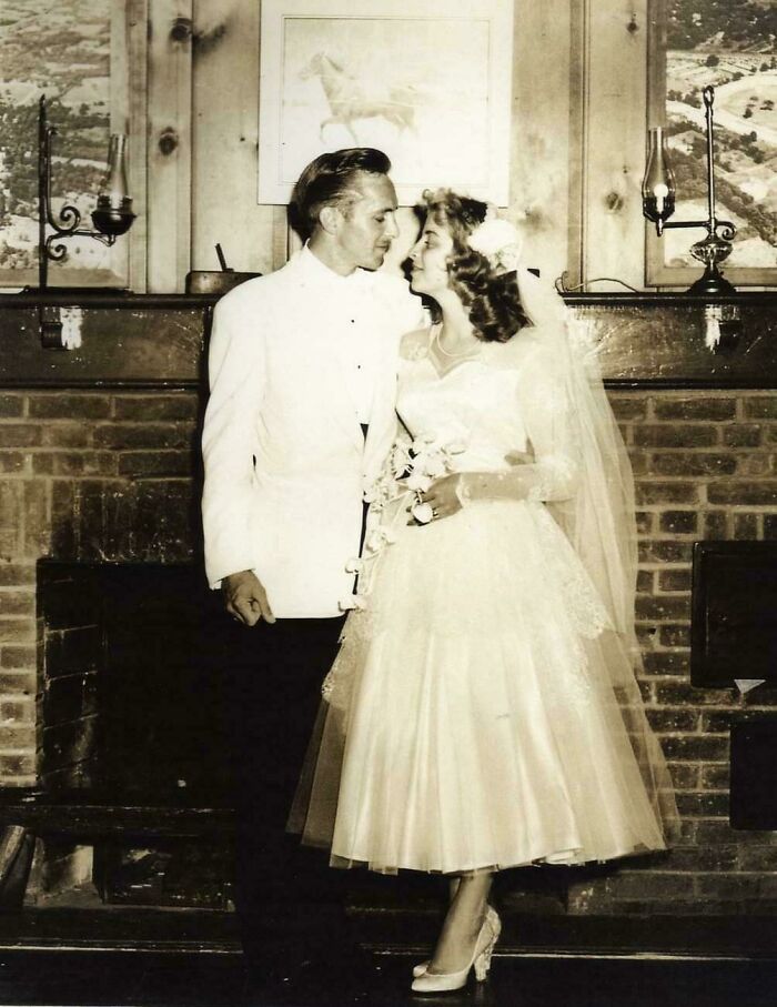 Vintage wedding couple in elegant attire, sharing a moment in a rustic setting, showcasing beautiful old pics and nostalgia.