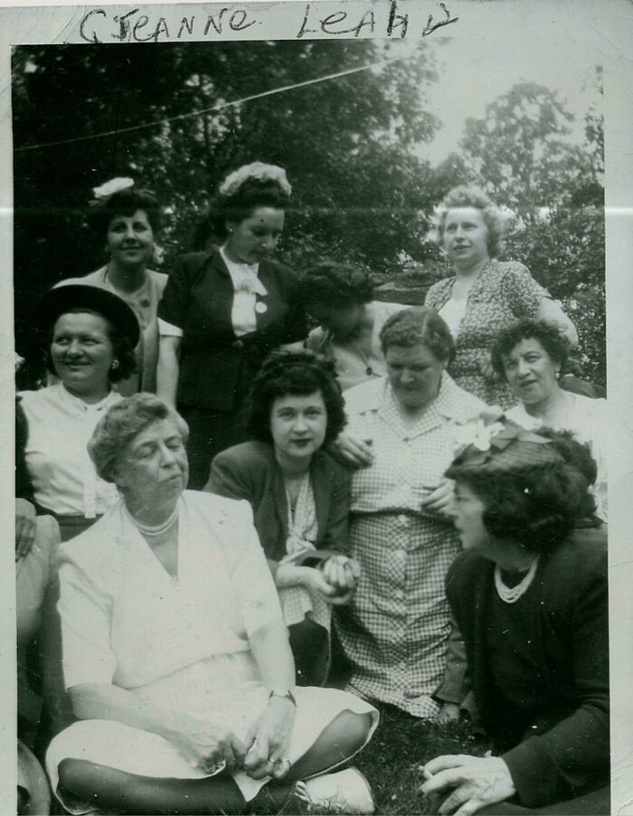 Group of women socializing outdoors in vintage attire, evoking nostalgic memories of the past.