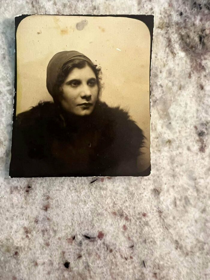Vintage photo of a woman in a headscarf and fur collar, embodying beautiful and interesting historical moments.