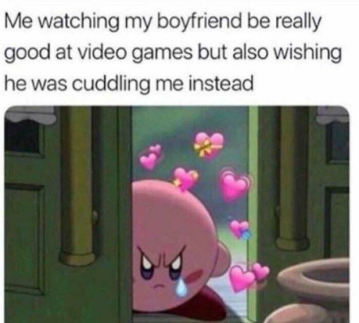 Character with a tear and hearts wishing for love while watching someone play video games.