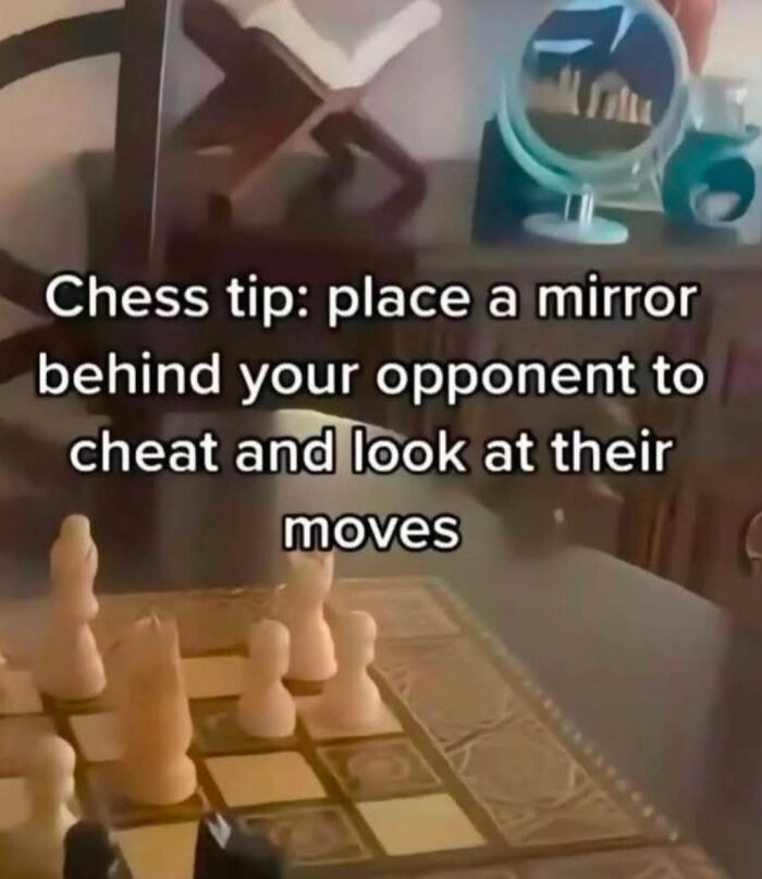 Chess board with a funny tip about using a mirror to see your opponent's moves, showcasing a confidently incorrect idea.