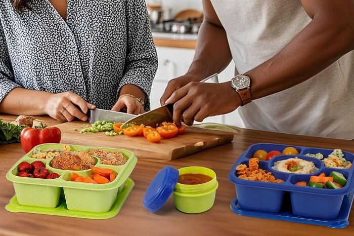 Couple preparing fresh vegetables with colorful sectioned lunchboxes from an Amazon haul on a kitchen counter.