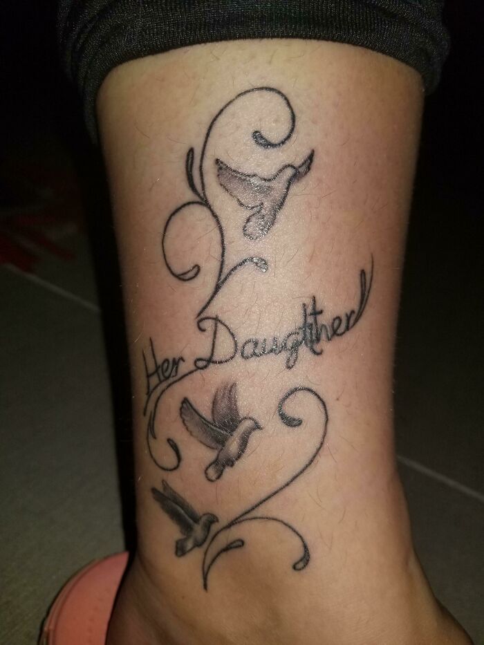 Tattoo fail showing misspelled "Her Daughter" with birds and decorative swirls on a person's leg.