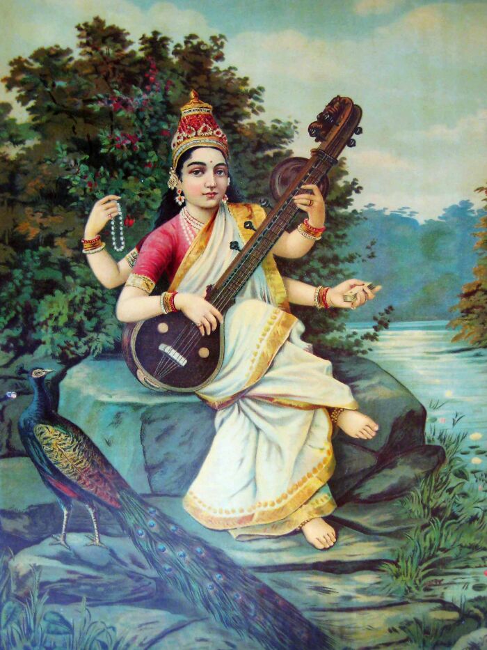 Hindu goddess playing veena seated on rock near peacock in a nature setting representing triple threat deities concept
