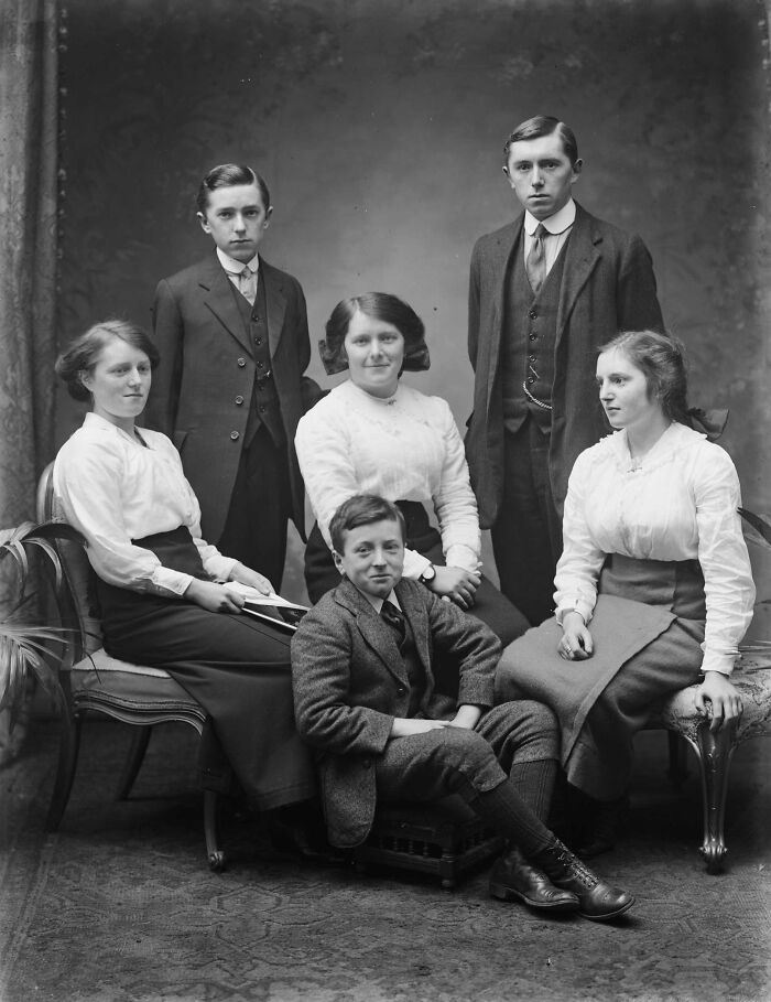Group portrait of six young adults in early 20th century attire, a rare photograph rescued from glass negatives.