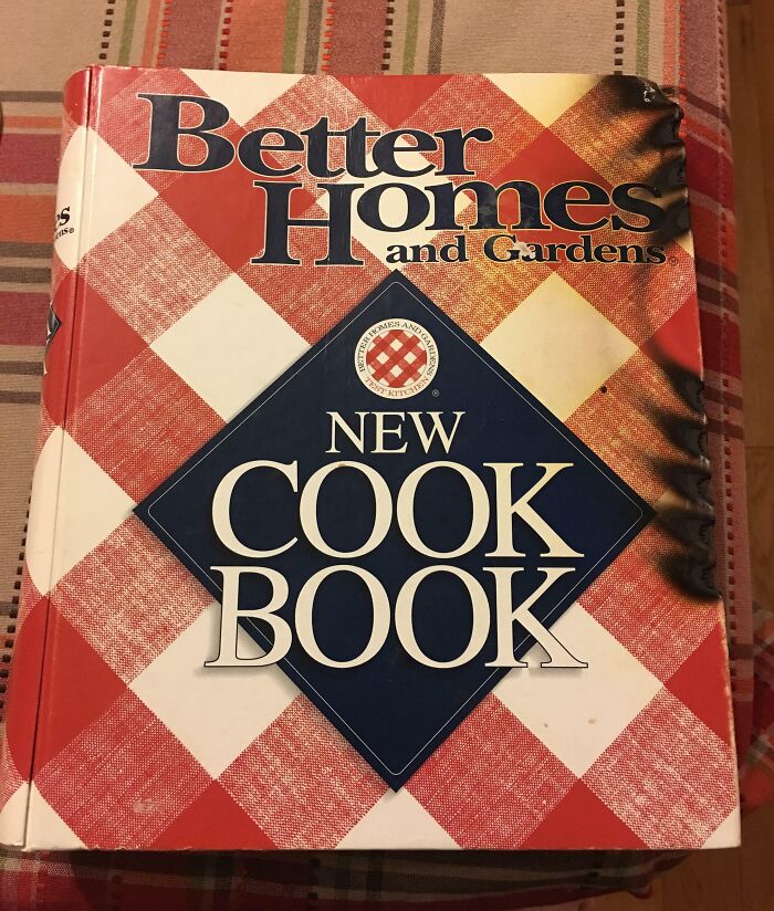 Burnt corner of "Better Homes" cookbook, adding to a worse day vibe.