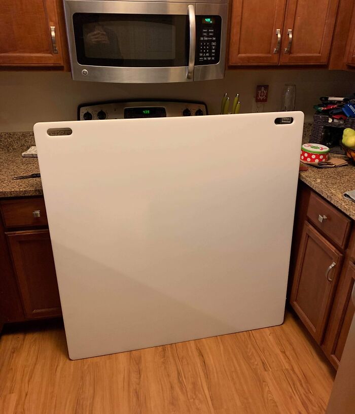 Large fridge door blocking kitchen pathway, illustrating a bad day scenario.
