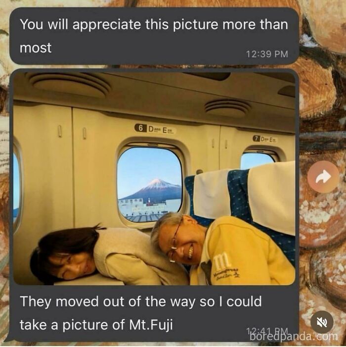 Two people on a train move to capture a pure and uplifting moment with Mt. Fuji perfectly framed through the window.