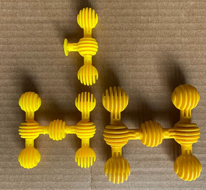 Yellow interlocking sensory toys arranged on a cardboard surface, popular among kids for tactile play and engagement.