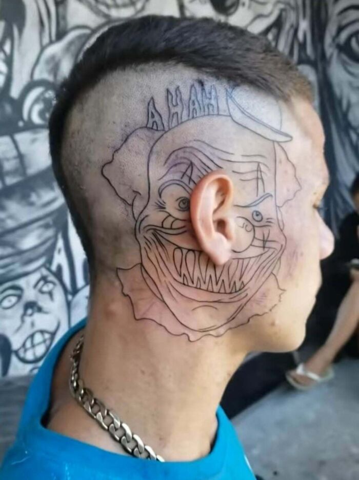 Outline of a scary clown tattoo inked on the side of a man's head, showcasing one of the wild tattoo fails.