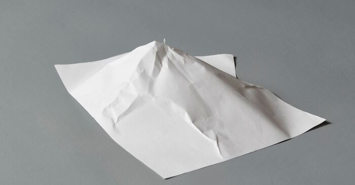 Paper mini world art by Peter Callesen depicting a small mountain on a flat surface.