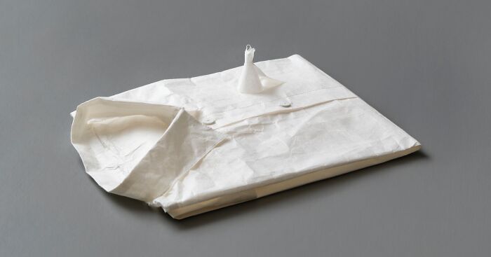 Miniature world and shirt sculpture made from paper by Peter Callesen.