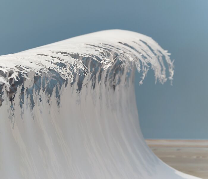 Paper art miniature resembling a wave, crafted by Peter Callesen.