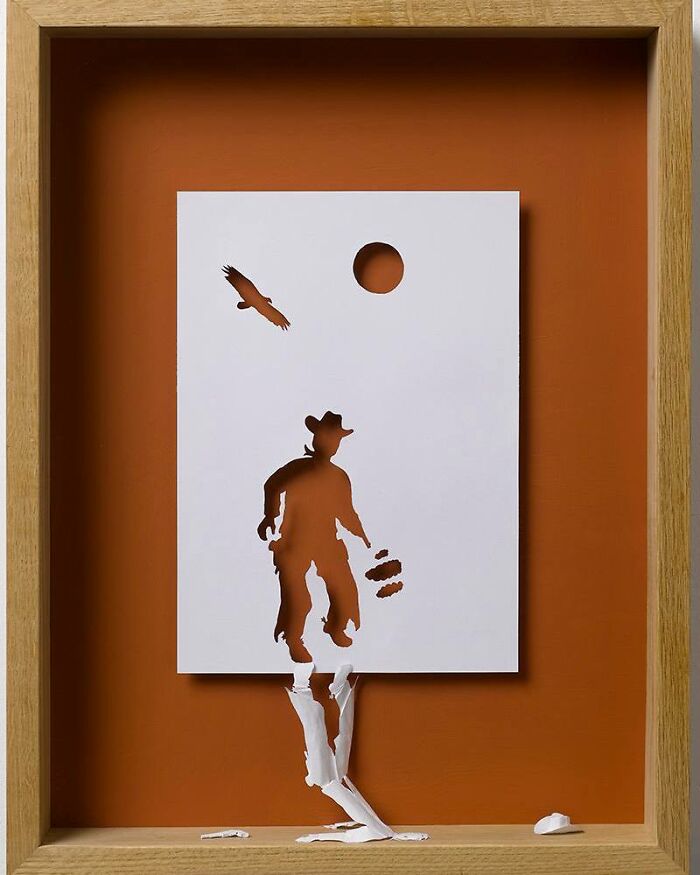 Paper cut art of a cowboy and bird on an orange background.