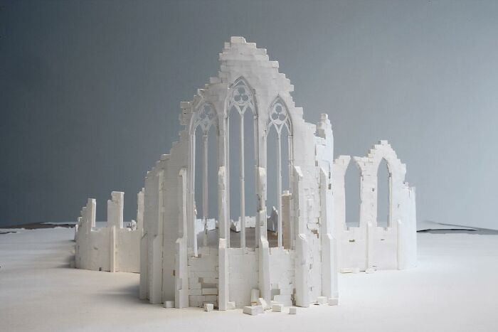 Paper sculpture resembling a gothic cathedral, crafted by Peter Callesen.