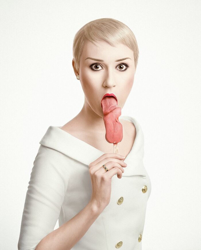 Artist in a white dress with short hair holds a surreal tongue-shaped ice cream, showcasing Photoshop dreams.