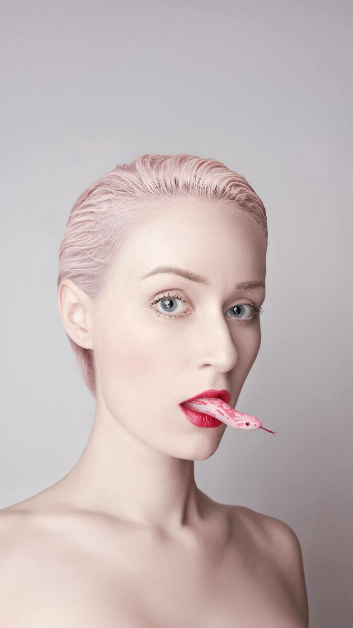 Artist's surreal self-portrait with pink snake emerging from lips, illustrating dreamlike imagery.