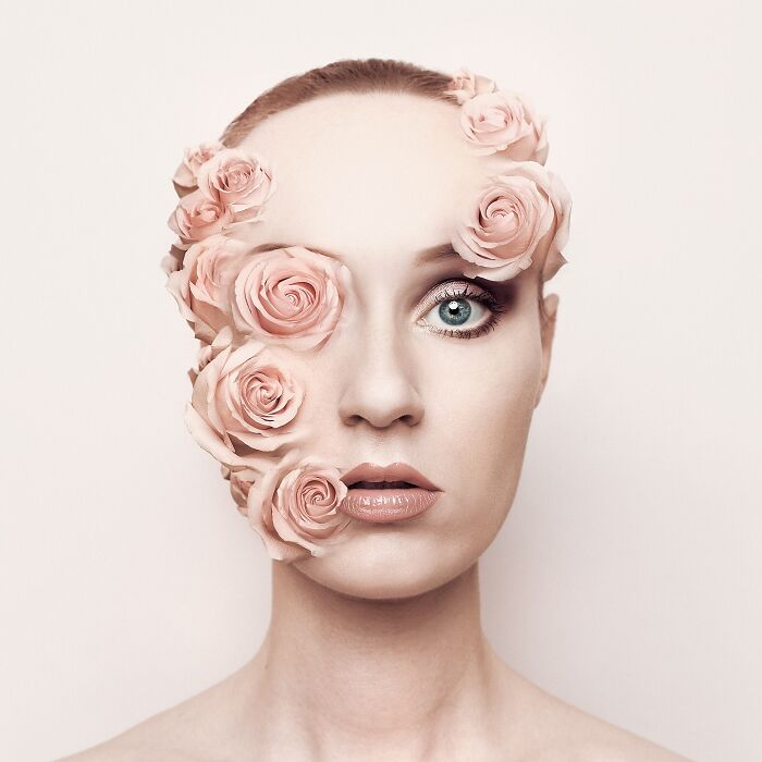 Surreal self-portrait featuring a woman with pink roses covering parts of her face, blending dreams and reality.