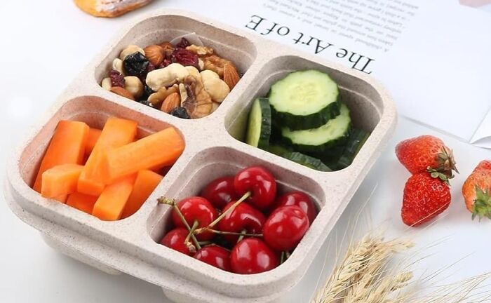 Reusable divided food container with fresh fruits and vegetables, showcasing affordable kitchen deals from Amazon haul.