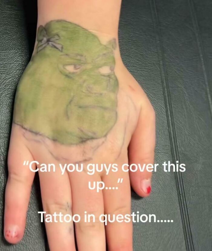 Hand with a poorly executed green face tattoo, showcasing one of the wild tattoo fails now someone’s forever problem.