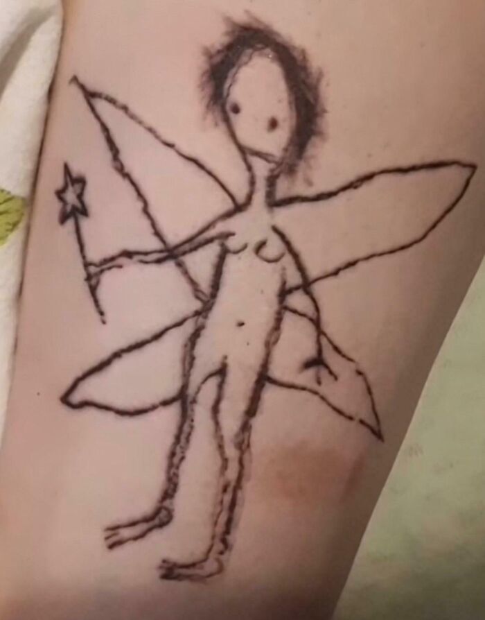 Tattoo fail of a poorly drawn fairy with star wand and wings on skin, a wild tattoo fail now someone's forever problem.