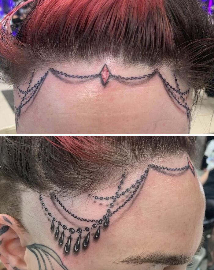 Face jewelry tattoo fail featuring uneven black and red ink lines with droplet designs on the forehead and temple areas.