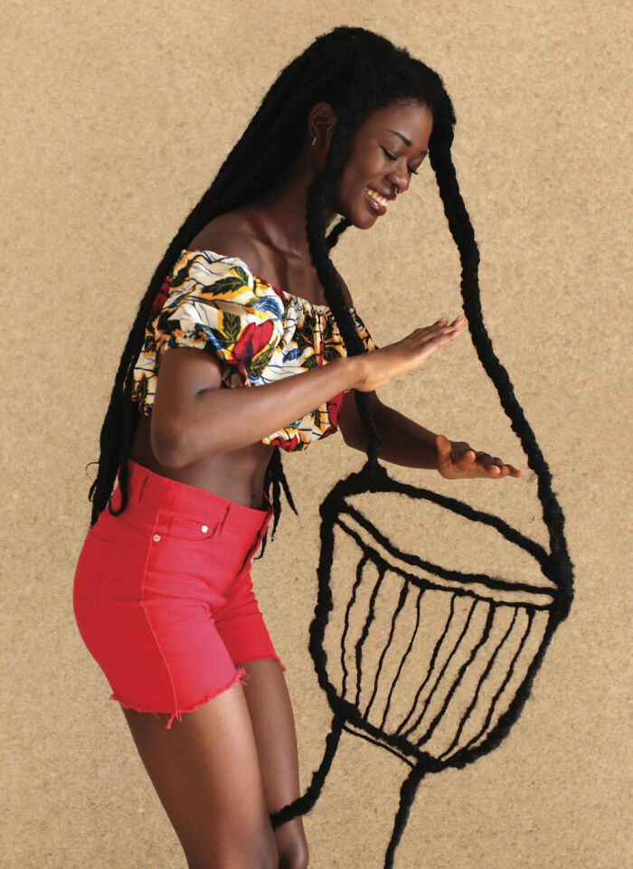 Woman creates a hair sculpture resembling a drum.