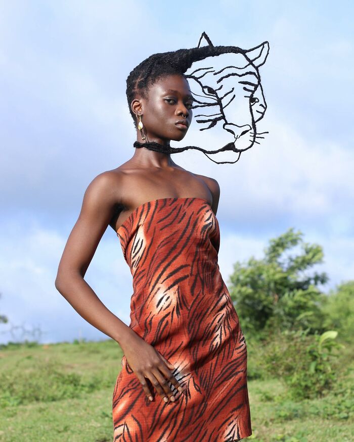 Woman wearing a tiger-print dress with hair styled into a sculpted lion face, demonstrating hair sculpture art.