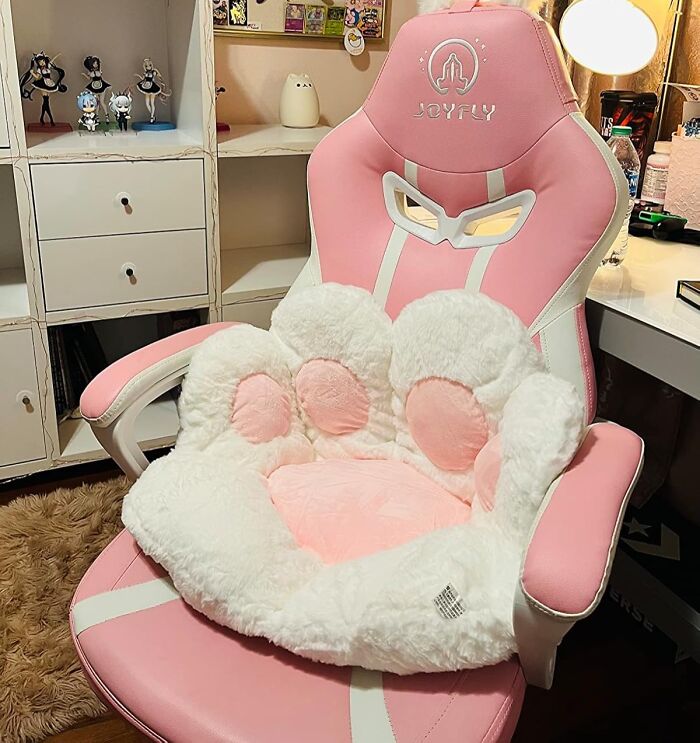 Pink gaming chair with a fluffy paw-shaped cushion, perfect for items that unleash your inner child.