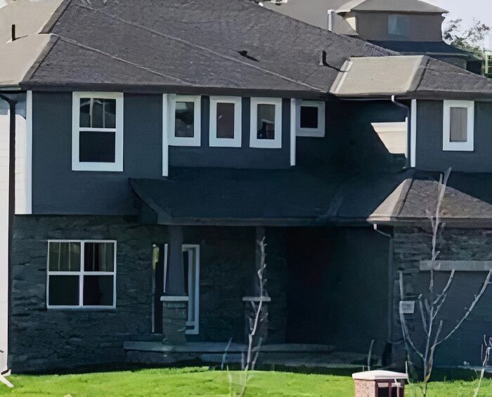 Unusual house design with misaligned windows featured on "I Want To Leave Ok" Instagram account.