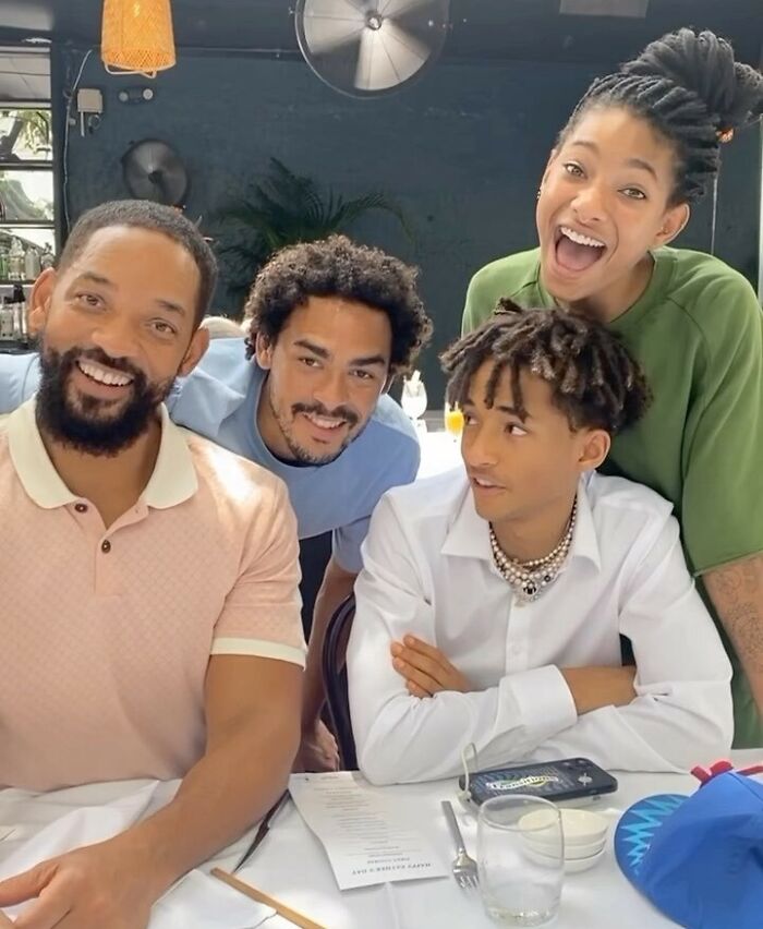 Will Smith and family smiling together at a restaurant, a positive example of celebrity encounters with fans.