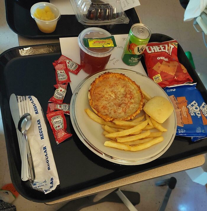 Hospital tray with personal pizza, fries, roll, snacks, and drink illustrating pure and uplifting moments in daily life.