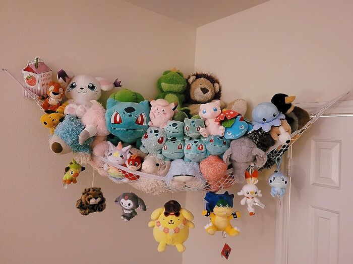 Plush toys neatly stored in a corner hammock, showcasing genius organization finds under $20 for home improvement.