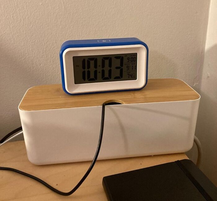 Cable management box with a digital clock on top, demonstrating genius organization finds under $20 for home use.