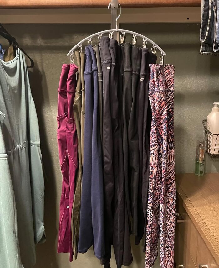 Closet organization hack with a circle hanger holding multiple pairs of pants to save space and keep clothes tidy.