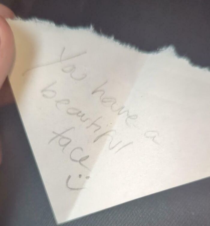 Handwritten uplifting note saying you have a beautiful face, capturing pure and uplifting moments for daily scroll.
