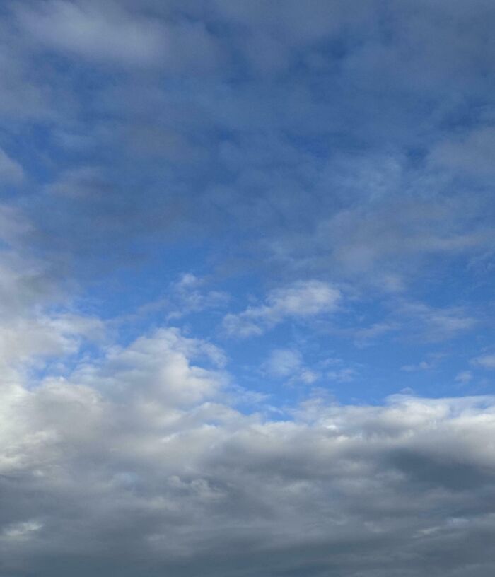 Blue sky with soft clouds, capturing pure and uplifting moments perfect for your daily scroll and positive vibes.