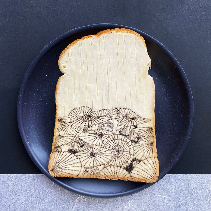 Creative toast design with intricate line patterns on a black plate.
