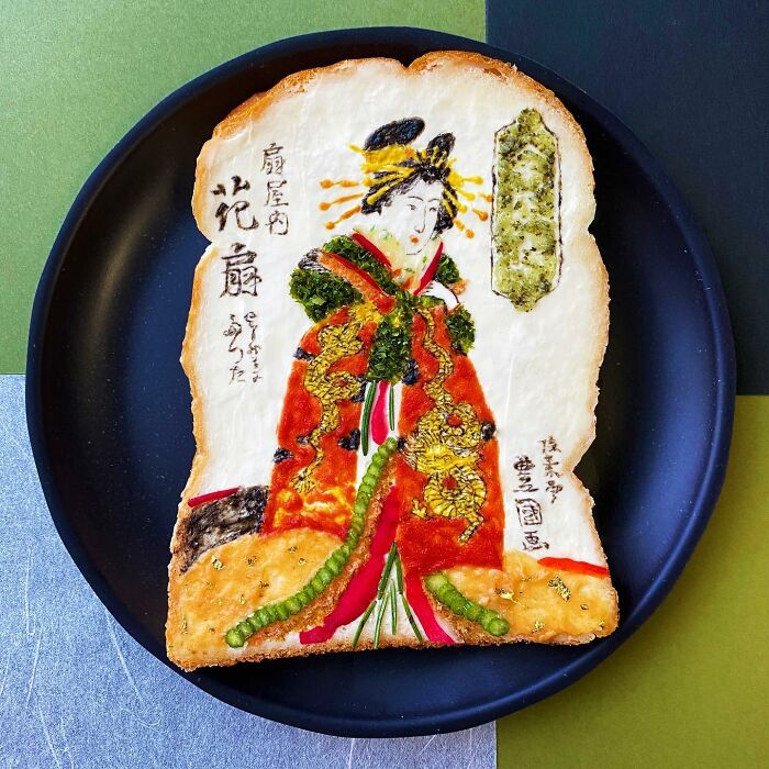 Creative toast design featuring intricate artwork by Japanese artist, displayed on a black plate.