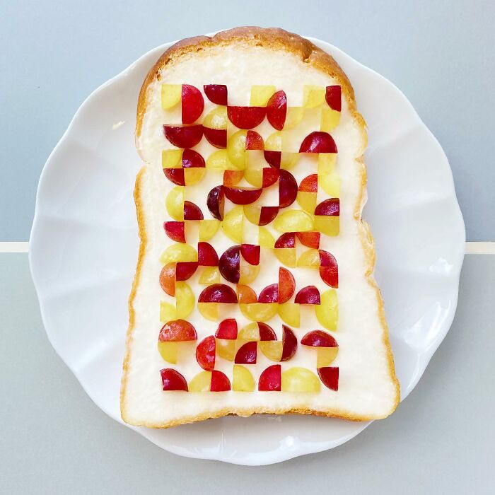 Creative toast design by a Japanese artist featuring a colorful geometric fruit pattern on a slice of bread.