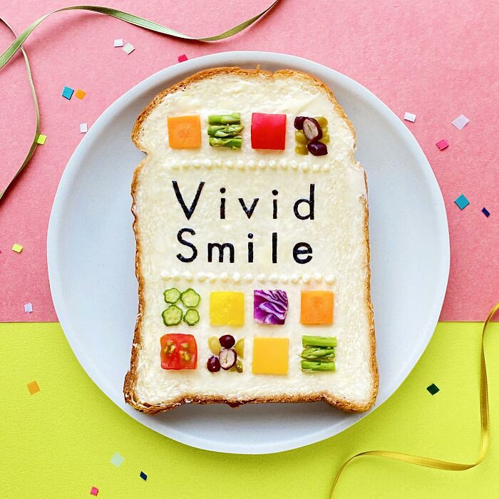 Creative toast design by Japanese artist featuring "Vivid Smile" text with colorful vegetable squares on a pink and yellow background.