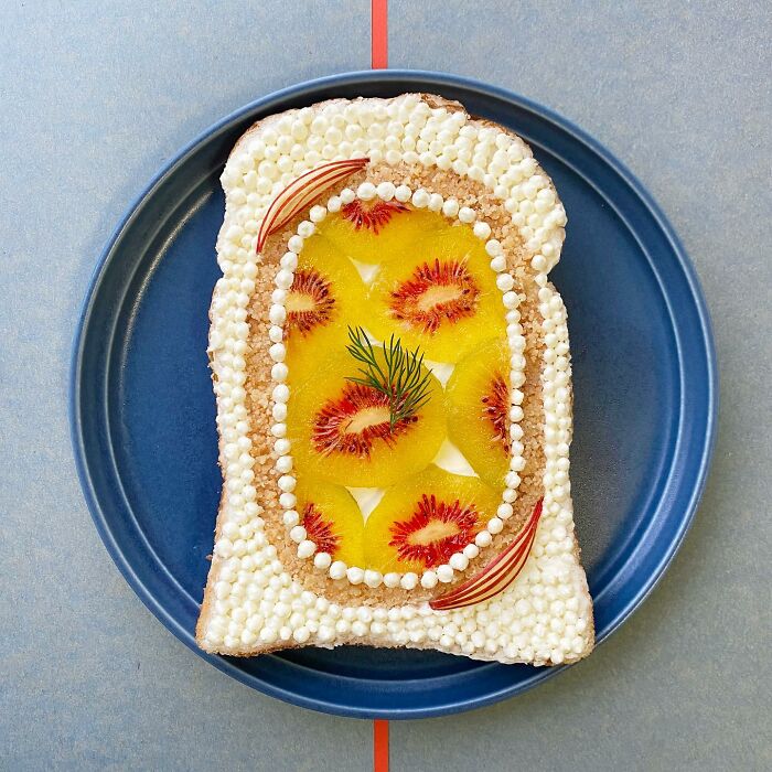 Creative toast design with artistic toppings on a blue plate.