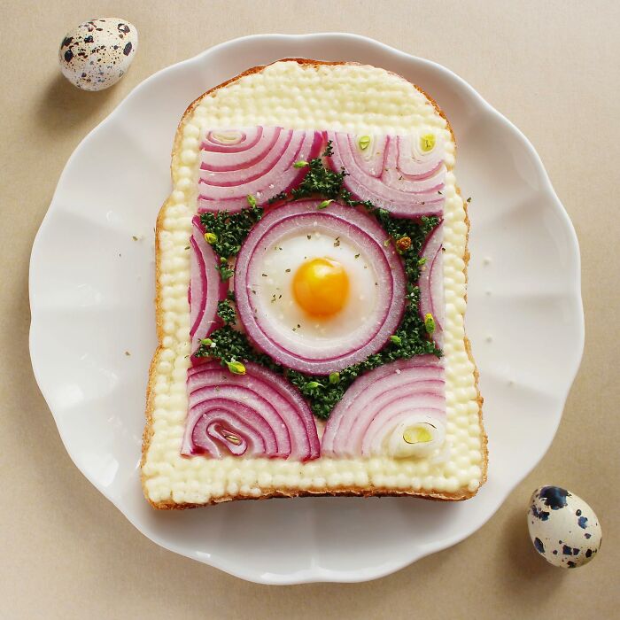 Creative toast design with egg, red onion, and greens on a plate, showcasing Japanese artistry.