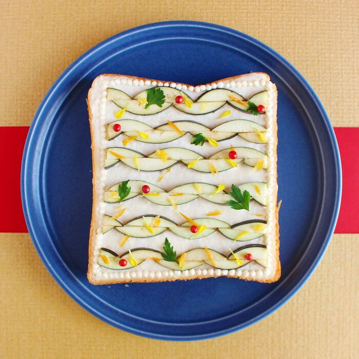 Creative toast design featuring elegant patterns with vegetables on a blue plate.