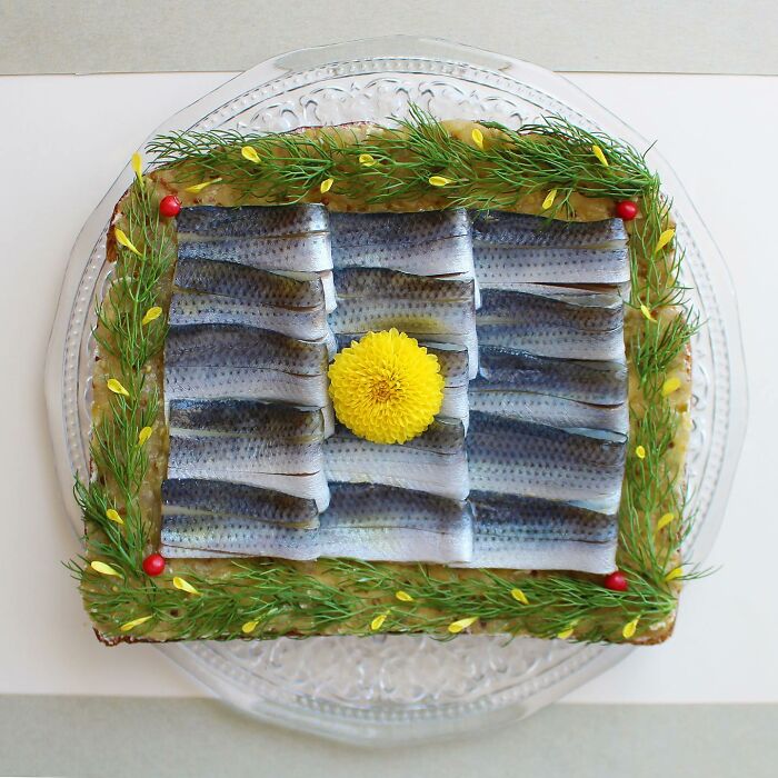 Creative toast design with sardines and a floral garnish by Japanese artist.