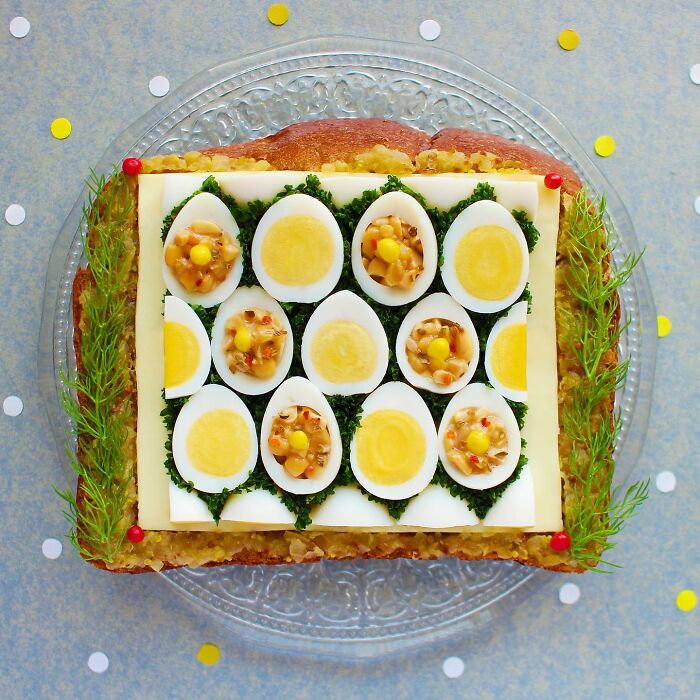 Creative toast design with boiled eggs and garnish by Japanese artist on a decorative plate.