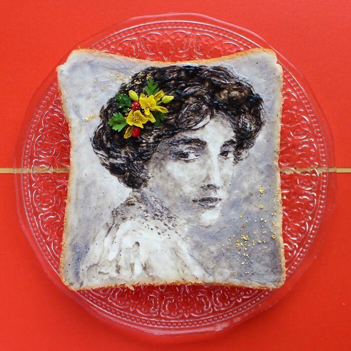 Creative toast design featuring intricate portrait art by a Japanese artist on a slice of bread with floral decoration.