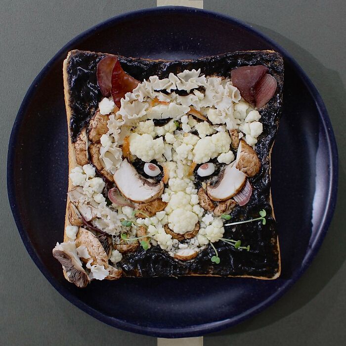 Creative toast art by Japanese artist, featuring a detailed animal face made with vegetables on toasted bread.