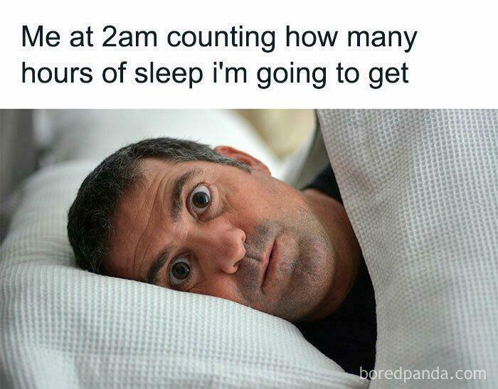 Man wide-eyed in bed at 2am counting hours of sleep, illustrating funny memes relatable to anxiety struggles.